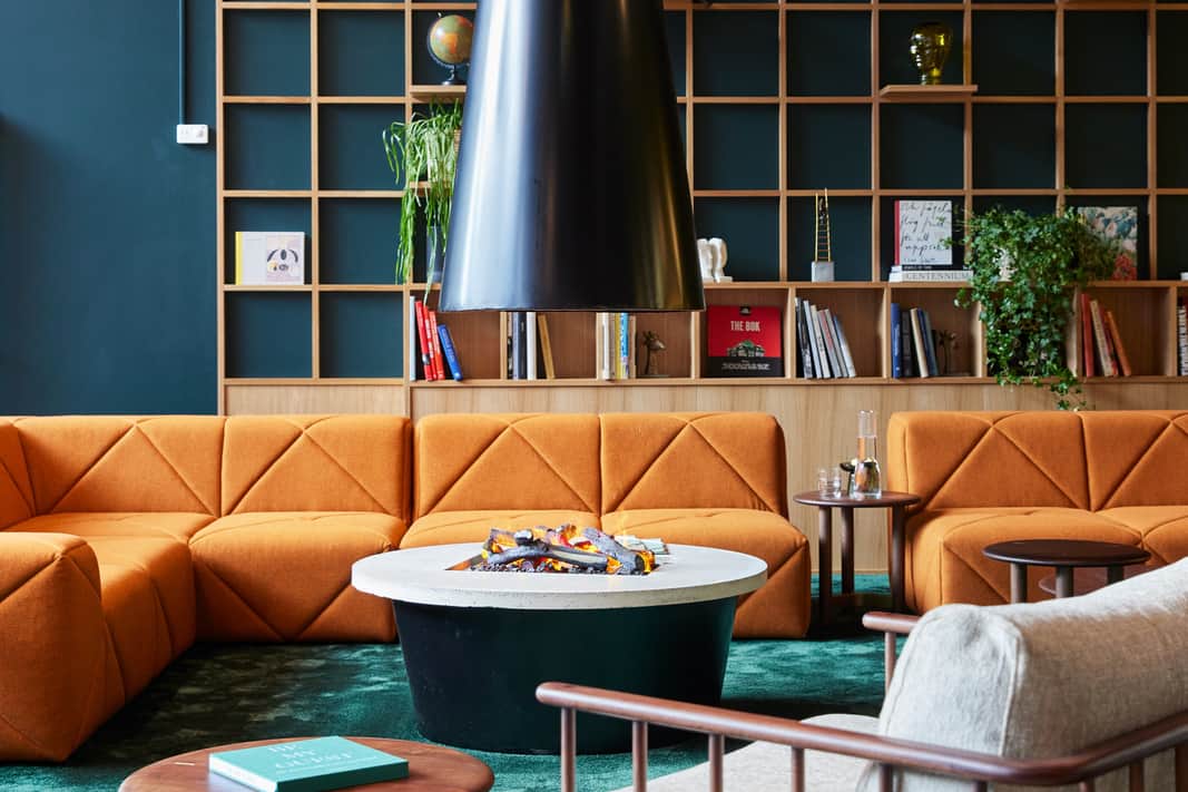 Lounge area with orange sofas.