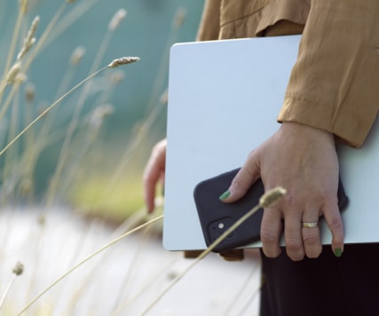 Closeup of person holding a laptop.