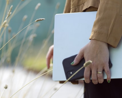 Closeup of person holding a laptop.