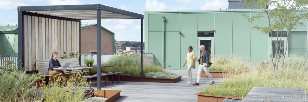 Three people on a roof terrace.