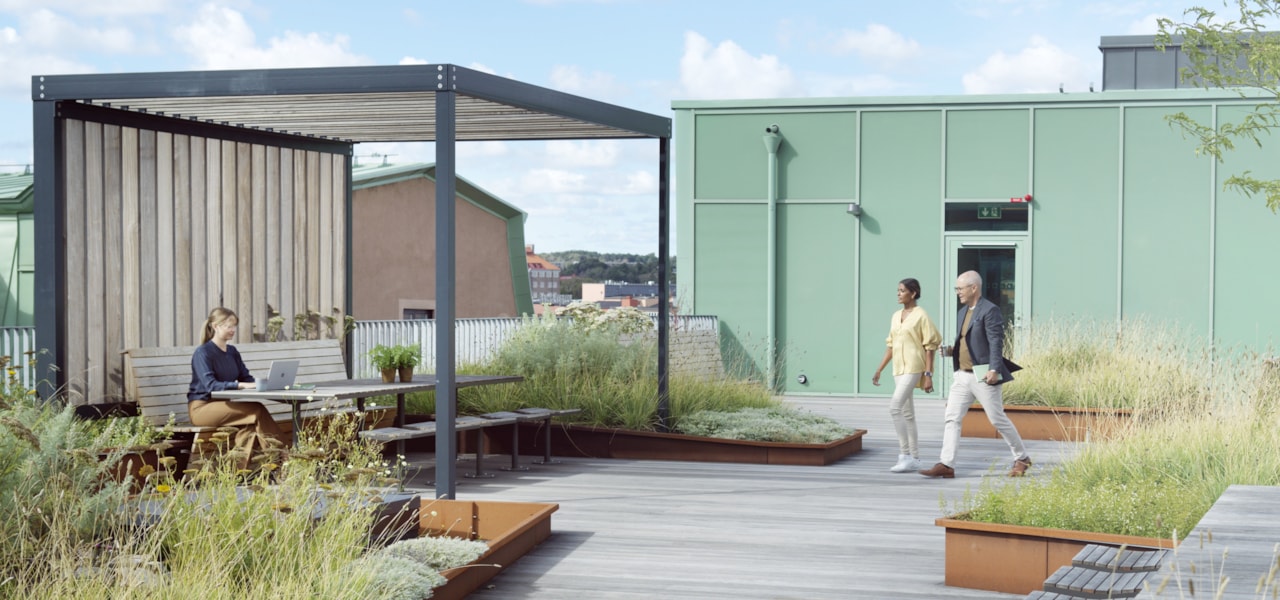 Three people on a roof terrace.