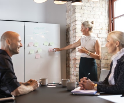 Three persons in a meeting room