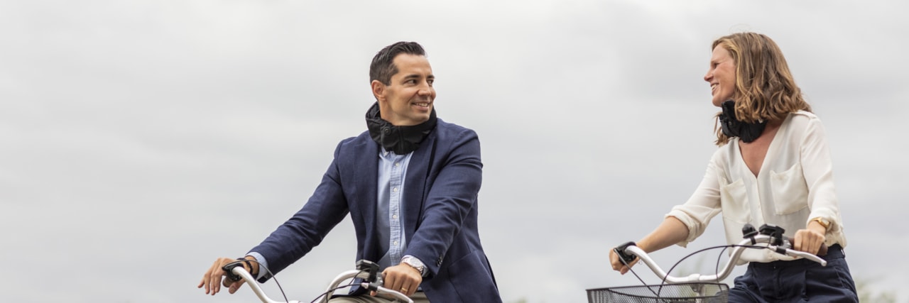 Two people riding bikes.