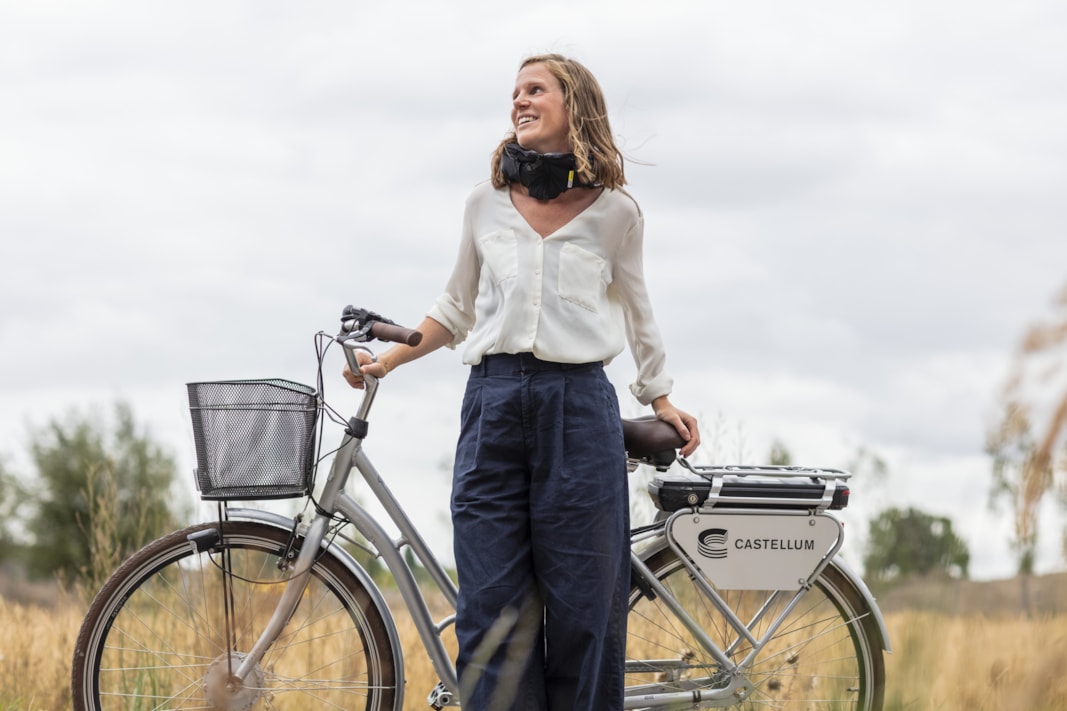 Person standing with a bike.
