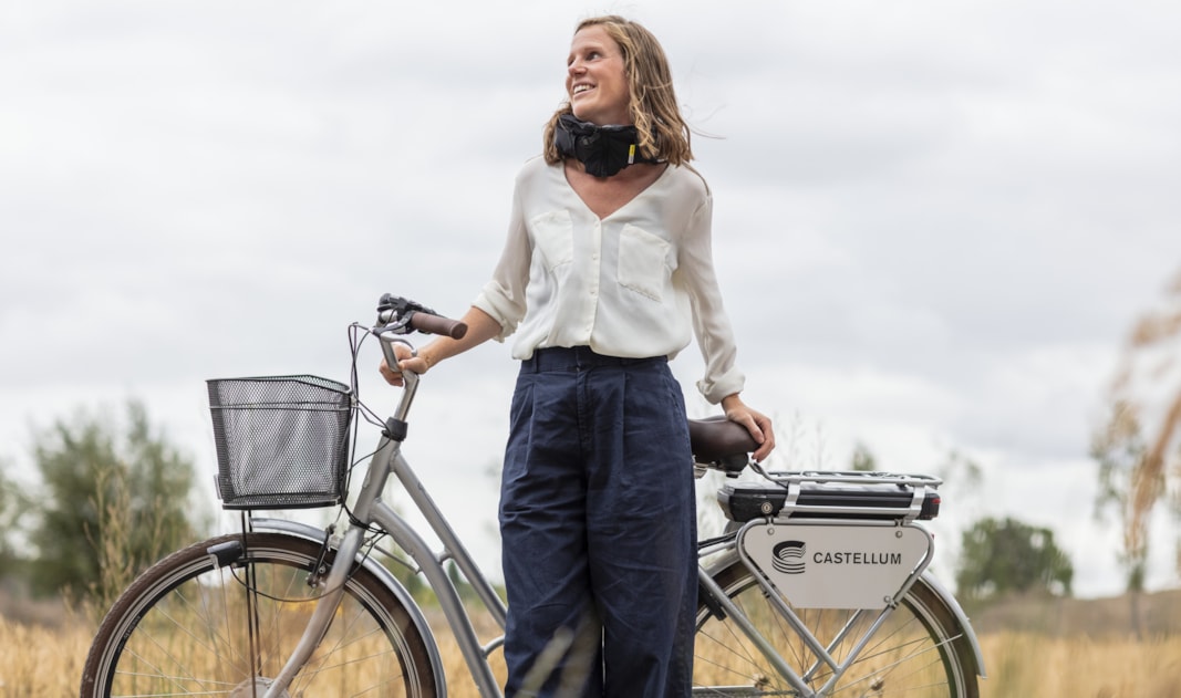 Person standing with a bike.