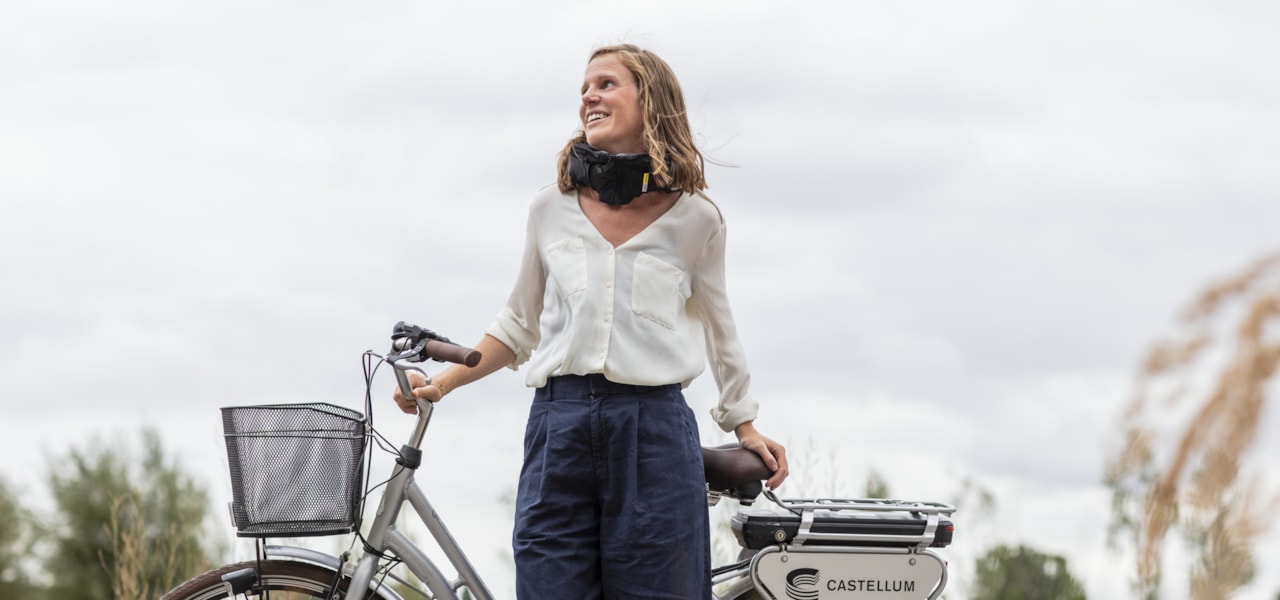 Person standing with a bike.