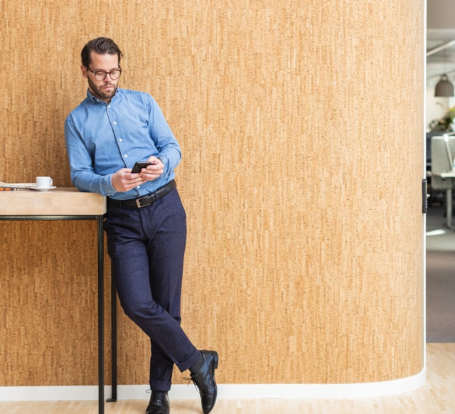 Man standing against a wall.