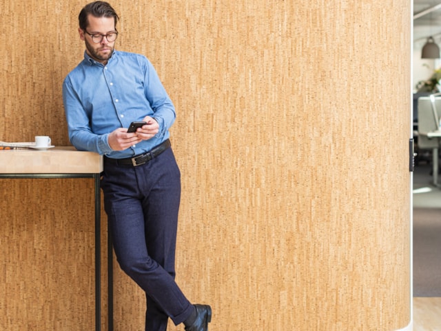 Man standing against a wall.