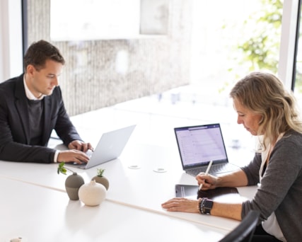 Two people with laptops.