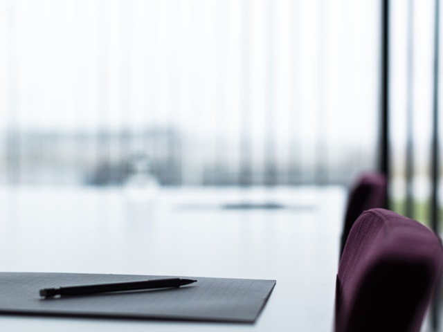 Closeup of a table in a conference room.