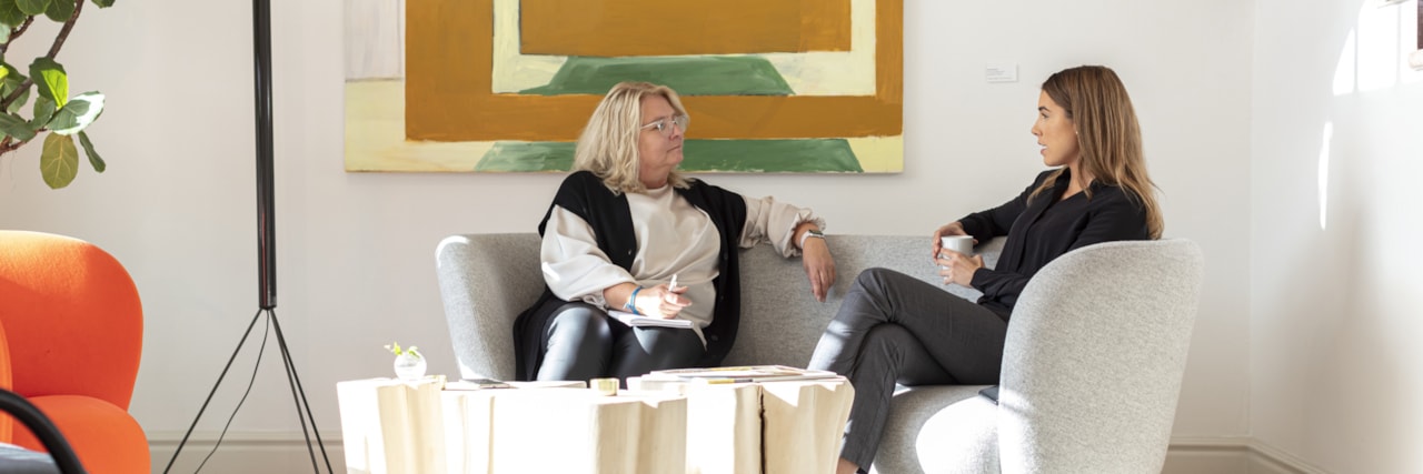 Two people sitting in a sofa.