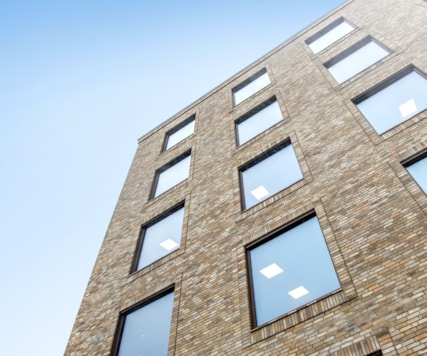 Upwards view of the facade of a brick property.
