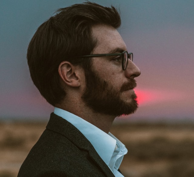 Close up picture of man with beard and dark hair