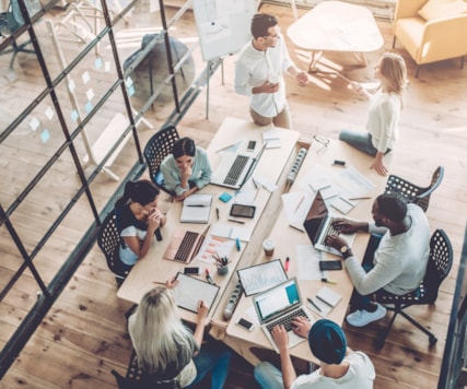 People sitting around a big desk.